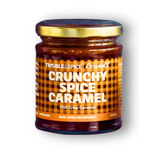 Jar of Crunchy Spice Caramel, a chili crisp dessert sauce made with crispy chilli oil chili olie .