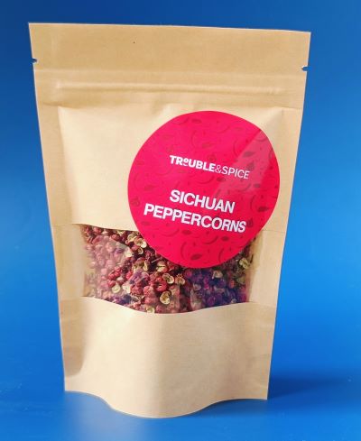 Brown paper pouch of Sichuan peppercorns from Trouble & Spice, whole dried peppers used for Chinese cooking and spicy dishes.