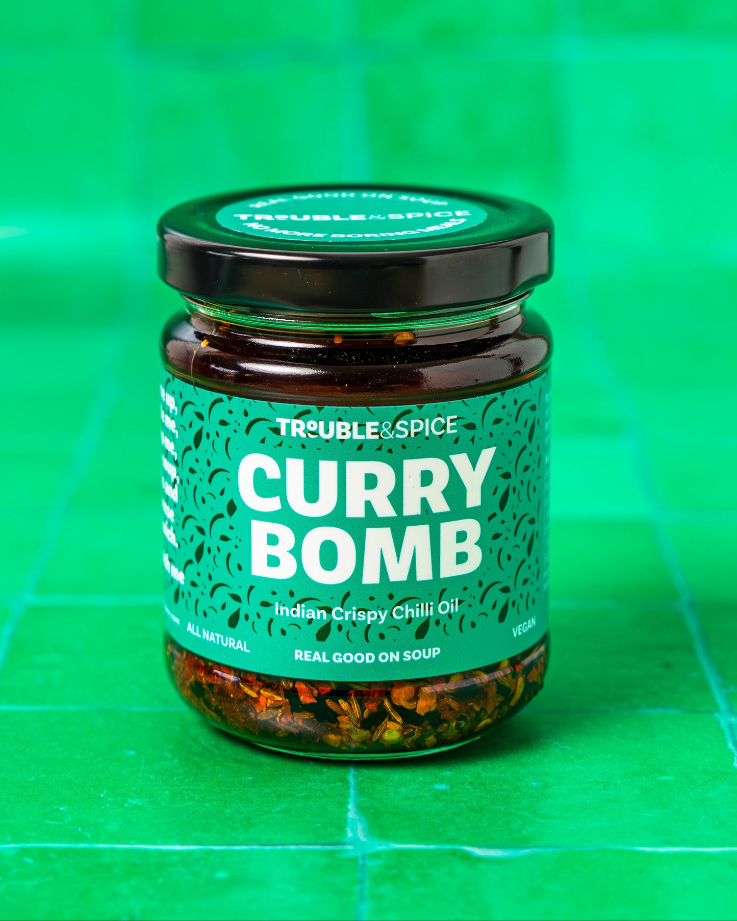 Jar of 'Curry Bomb' on a green checkered background