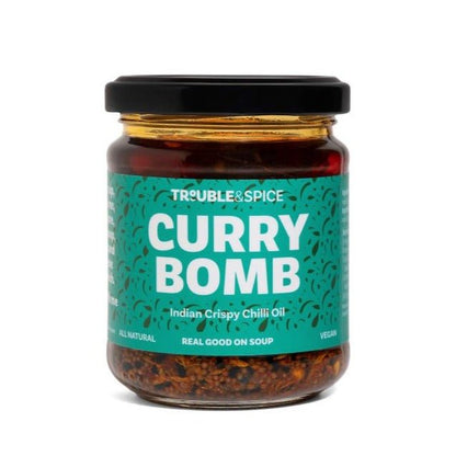 Jar of Trouble & Spice Curry Bomb, an Indian crispy chilli oil (chii olie) with a teal label and black lid.