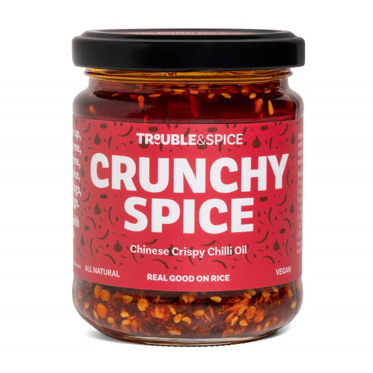 Trouble & Spice Crunchy Spice Chinese Crispy chilli oil - chili olie in a glass jar with bold red label, featuring visible chili flakes and seeds.